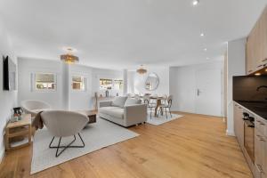 a living room with a couch and a table at Le Belvedere By Alaïa in Crans-Montana