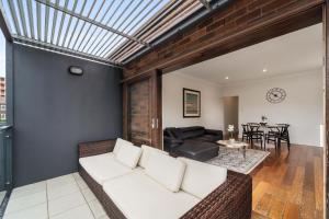 a living room with a couch and a table at Breathtaking Sydney Harbour view condo in Sydney