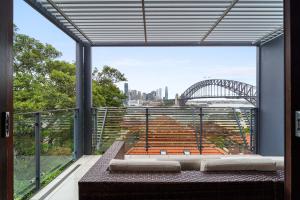 a balcony with a view of the sydney opera house at Breathtaking Sydney Harbour view condo in Sydney