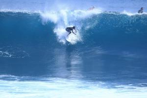 a man riding a wave on a surfboard in the ocean at Future in Taghazout