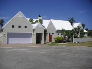 a white house with a large garage at Waterside Living MM1297 in Jeffreys Bay