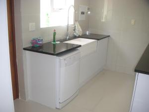 a white kitchen with a sink and a dishwasher at Waterside Living MM1297 in Jeffreys Bay +45 photos
