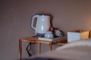 a small table with a blender on top of it at The Breeze Glamping in Bangli
