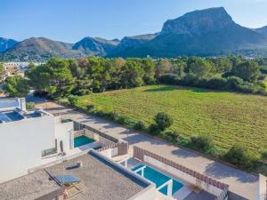 an aerial view of a house with a pool and mountains at Villa Montfarrutx in Colonia de Sant Pere