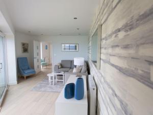 a living room with a couch and a table at 7 Atlantic Watch in St Ives