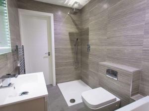 a bathroom with a toilet and a sink and a shower at 7 Atlantic Watch in St Ives +12 photos
