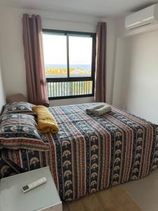 a bedroom with a bed and a window with a view at StellaPremium in Salvador +26 photos