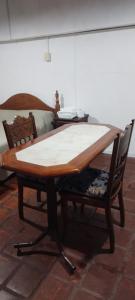 a wooden table with two chairs around it at Las Glicinas in Villa Mercedes +9 photos