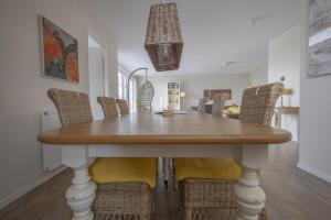 a dining room with a table and chairs at Duinhof II 21 in Cadzand