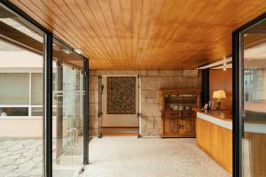 an open lobby with a wooden ceiling and a door at Pousada Valença do Minho in Valença