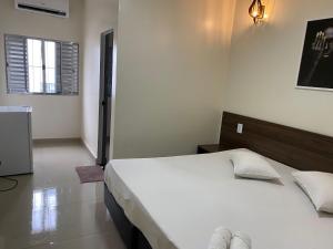 a bedroom with a large white bed in a room at Hotel Novo Apúlia in Sao Paulo +31 photos