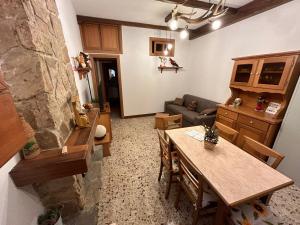 a living room with a table and a couch at Sangro River Casa Vacanza in Castel di Sangro