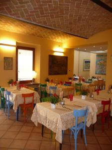 a restaurant with tables and chairs in a room at Albergo Ristorante Corsini in Pavullo nel Frignano