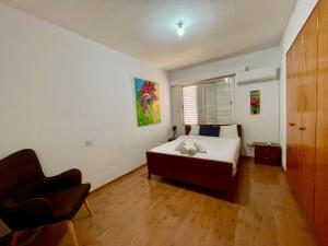 a bedroom with a bed and a chair in it at Comfort Stay in Nicosia - Aglantzia RIK in Nicosia