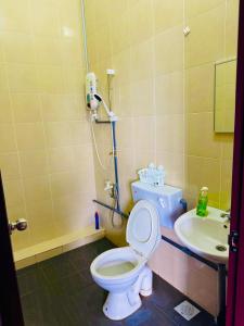 a bathroom with a toilet and a sink at HmHome-five in Sibu +9 photos