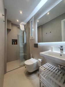 a bathroom with a toilet and a sink and a shower at Hi Hellas 4 in Artemida +25 photos