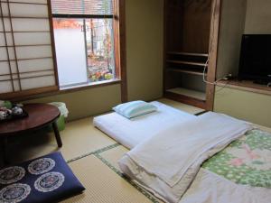 Postel nebo postele na pokoji v ubytování Ryokan Matsukaze