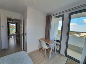 a room with a bed and a table with a view at Hi Hellas 4 in Artemida