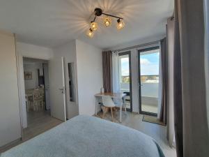 a bedroom with a bed and a table and window at Hi Hellas 4 in Artemida