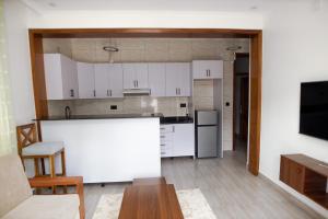 a kitchen with white cabinets and a white counter top at MARA Apartments in Gisenyi