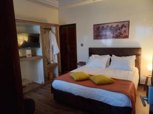 Ein Bett oder Betten in einem Zimmer der Unterkunft Zebra Résidence