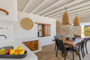 a kitchen and dining room with a table and chairs at Myconian Platinum Senior & Deluxe Villas in Kalafatis