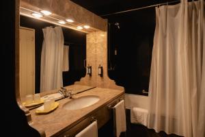 a bathroom with a sink and a mirror and a shower at Pousada de Valença in Valença +54 photos