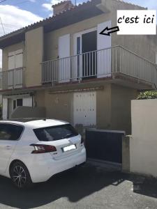 a white car parked in front of a house at Plage des Chalets in Gruissan +8 photos