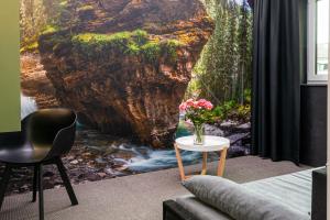 a living room with a painting of a waterfall at Hotel Parkzicht in Valkenburg