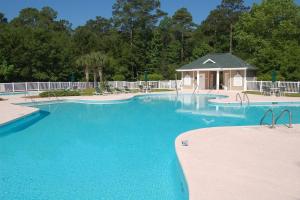 a large blue swimming pool with a gazebo at 2 Bedroom Golf Villa in Pawleys Island in Pawleys Island