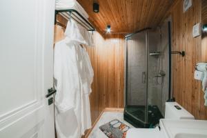 a bathroom with a shower and a toilet and a sink at Asman Glamping in Karakol