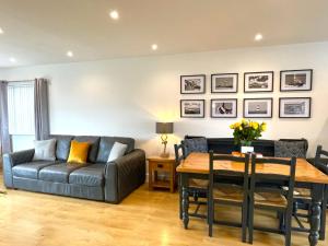 a living room with a couch and a table at Bungalow33 Benllech in Benllech