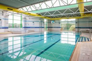 a large swimming pool with blue water at Holiday Inn Stoke on Trent M6 Jct15, an IHG Hotel in Stoke on Trent