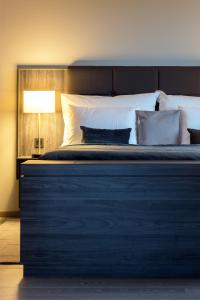 a bedroom with a large bed with a black and white at Clarion Hotel Air in Sola
