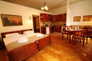 a room with a bed and a kitchen with a table at Ventus Rosa Apartments in Krakow