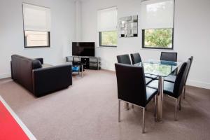 a living room filled with furniture and a tv at The Star Apartments in Newcastle