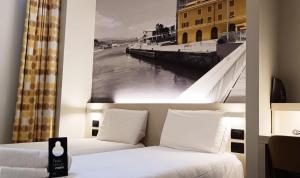 Кровать или кровати в номере B&B Hotel Savona