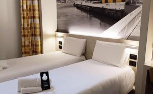 Кровать или кровати в номере B&B Hotel Savona