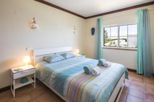 a bedroom with a bed and a window at Terraços de Benagil 23 (Casa Alvorada) in Benagil +37 photos