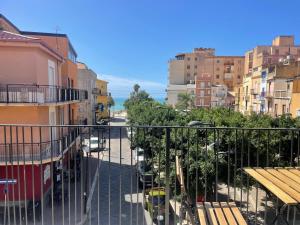 a balcony with a view of a city with buildings at Casa faro in Realmonte