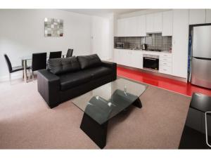 a living room filled with furniture and a coffee table at The Star Apartments in Newcastle