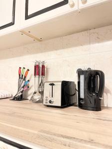 a kitchen counter with a toaster and appliances on it at Shepherds House - 3 bedroom in Goodmayes