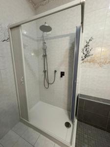 a shower with a glass door in a bathroom at Stefano's house in Siracusa +7 photos