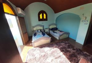 an overhead view of a bedroom with two beds at Malika nubian house in Aswan