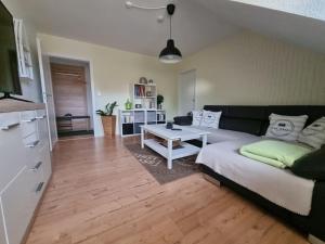 a living room with a couch and a table at Haus Jümmeblick in Detern