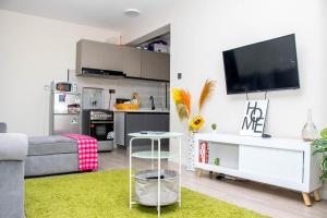 a living room with a couch and a tv at Aries Residence Sabaki in Nairobi