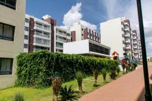 a large green hedge in front of a building at Aries Residence Sabaki in Nairobi