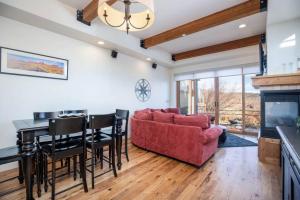 a living room with a red couch and a table at Mountain Retreat Hot Tub Views,Near Shops in Park City