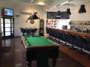 a pool table in a bar with chairs and a counter at Fish Creek Hotel in Fish Creek