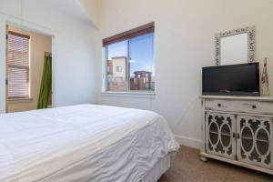 a bedroom with a bed and a flat screen tv at Mountain Retreat Hot Tub Views,Near Shops in Park City